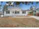 Newly renovated ranch home with white brick exterior, landscaped lawn, and covered porch at 131 Oakcliff Ct, Atlanta, GA 30331