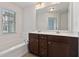 Bathroom with double vanity, soaking tub, and window at 5531 Radford Loop, Fairburn, GA 30213