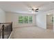 Loft area with carpet flooring, ceiling fan, and window at 5531 Radford Loop, Fairburn, GA 30213