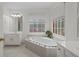 Bright bathroom with a large soaking tub and double vanities at 308 Mainsail Ln, Woodstock, GA 30189