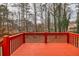Red deck with wooded backdrop at 308 Mainsail Ln, Woodstock, GA 30189