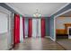 Bright dining room with hardwood floors and red curtains at 308 Mainsail Ln, Woodstock, GA 30189