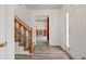 Bright entryway with hardwood floors, staircase, and view to living room at 308 Mainsail Ln, Woodstock, GA 30189