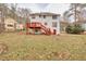 Rear view of house showcasing deck and landscaping at 308 Mainsail Ln, Woodstock, GA 30189