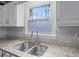 Kitchen with granite countertops and double stainless steel sink at 308 Mainsail Ln, Woodstock, GA 30189