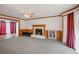 Living room with fireplace, wood paneling, and view to dining area at 308 Mainsail Ln, Woodstock, GA 30189