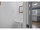 Small powder room with pedestal sink and decorative mirror at 308 Mainsail Ln, Woodstock, GA 30189