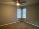 Well-lit bedroom featuring neutral walls, carpet, and window at 5391 Kelleys Mill Cir, Stone Mountain, GA 30088