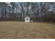 Backyard with shed and wooded area at 2572 Plum St, Snellville, GA 30078