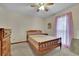Charming bedroom with wood bed frame and ceiling fan at 2572 Plum St, Snellville, GA 30078