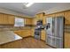 Kitchen with granite countertops, stainless steel appliances, and light wood cabinets at 2001 Commonwealth Way, Grayson, GA 30017