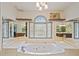 Bathroom with large jacuzzi tub, double vanity, and window at 3076 Hopkins Rd, Powder Springs, GA 30127