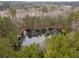 Aerial view of a serene pond surrounded by trees at 3076 Hopkins Rd, Powder Springs, GA 30127