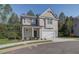 Two-story house with light beige siding, a white garage door, and a covered porch at 712 River Gardens Dr, Atlanta, GA 30354