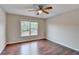 Spacious bedroom with hardwood floors and large window at 3930 Oak Park Dr, Suwanee, GA 30024