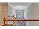 View of a staircase from second floor landing with chandelier at 3930 Oak Park Dr, Suwanee, GA 30024