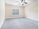 Bright bedroom featuring a ceiling fan and carpet flooring at 1609 Richmond Meadow Ct, Loganville, GA 30052