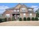 Two-story brick home with stone accents and a landscaped yard at 1609 Richmond Meadow Ct, Loganville, GA 30052