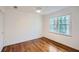 Simple bedroom with hardwood floors and large window at 2212 Brookfield Dr, Lawrenceville, GA 30043