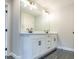 Double vanity bathroom with modern light fixtures at 1700 Fulmont Cir, Mableton, GA 30126