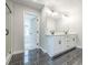 Double vanity bathroom with dark tile floors at 1700 Fulmont Cir, Mableton, GA 30126