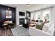 Living room with white sofas, a fireplace, and hardwood floors at 139 Kingsley Way, Acworth, GA 30102