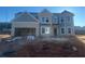 Two-story house with gray siding and brick accents under construction at 446 Rodeo Dr, Auburn, GA 30011