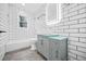 Modern bathroom with subway tile and a gray vanity at 1 Lamar Ave Nw, Atlanta, GA 30310