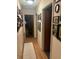 Long hallway with hardwood floors and framed Gathering photos at 5623 Westhill Cir, Atlanta, GA 30349