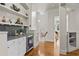 Custom wet bar with granite countertop, wine cooler, and ample shelving at 5920 Reddington Way, Sandy Springs, GA 30328