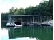 Covered boat dock with a boat in a slip at 3810 Reserve Overlook Lot14 Way, Cumming, GA 30041