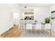 Bright dining room with modern light fixtures and hardwood floors at 1075 Peachtree Ne Walk # A517, Atlanta, GA 30309