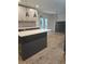 Modern kitchen with island, breakfast bar, and access to backyard at 2449 Maclaren Cir, Dunwoody, GA 30360