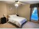 Cozy bedroom with a queen-size bed and window with blinds at 3711 Frey Lake Nw Rd, Kennesaw, GA 30144