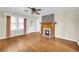 Living room with hardwood floors, fireplace, and ceiling fan at 3131 Front St, Ellenwood, GA 30294