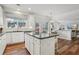 Island kitchen with white cabinets, granite counters and hardwood floors at 3077 Eastbrook Sw Ter, Atlanta, GA 30331