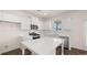 Bright kitchen featuring white cabinets, an island, and stainless steel appliances at 1009 Blue Juniper Cir, Loganville, GA 30052