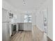Open concept kitchen features stainless steel appliances and hardwood floors at 525 Parkway Ne Dr # 217, Atlanta, GA 30308