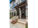 Townhome entrance with brick steps, dark brown door, and black railing at 1084 Battery Park Rd, Decatur, GA 30033