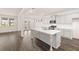 Modern kitchen with gray cabinets, a large island, and hardwood floors at 1019 Blue Juniper Cir, Loganville, GA 30052