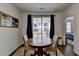 Small dining area with wooden table and chairs, near sliding doors to balcony at 129 Devore Rd # 205, Alpharetta, GA 30009