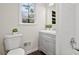 Updated bathroom with gray vanity, white tile, and bathtub at 1655 Murdock Rd, Marietta, GA 30062