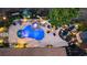 Aerial view of backyard oasis with pool, fire pit, and landscaping at 697 Hillwood Ct, Dacula, GA 30019