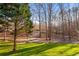 Long driveway leading through a wooded area to the house at 697 Hillwood Ct, Dacula, GA 30019