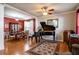 Living room featuring hardwood floors, a grand piano, and a formal dining area at 3750 Ridgefair Dr, Cumming, GA 30040