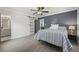 Bright bedroom with wood-look floors, barn door, and ceiling fan at 2053 Sandtown Sw Rd, Atlanta, GA 30311