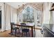 Charming dining room with wood table, black chairs and large windows overlooking yard at 3455 Summit Trl, Cumming, GA 30041