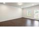 Spacious living room with dark hardwood floors and access to backyard at 3629 Fairhaven Dr # 66, Powder Springs, GA 30127