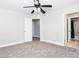 Spacious bedroom with ceiling fan and access to bathroom at 116 Big Cotton Trl, Mcdonough, GA 30252