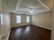 Main bedroom with ceiling fan and wood-look floors at 2250 Rosewood Mill Ct, Loganville, GA 30052